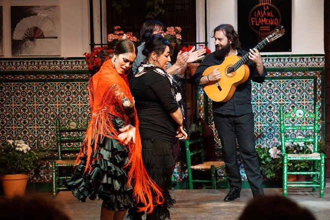 A flamenco dancer mid-turn under stage light